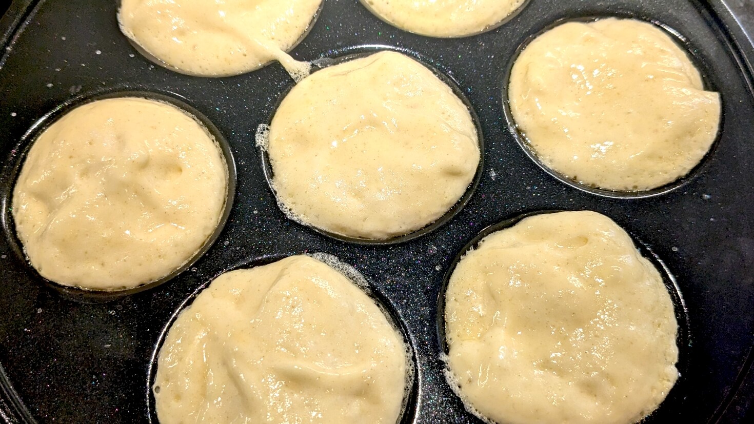 Raw aebleskiver batter in an aebleskive pan
