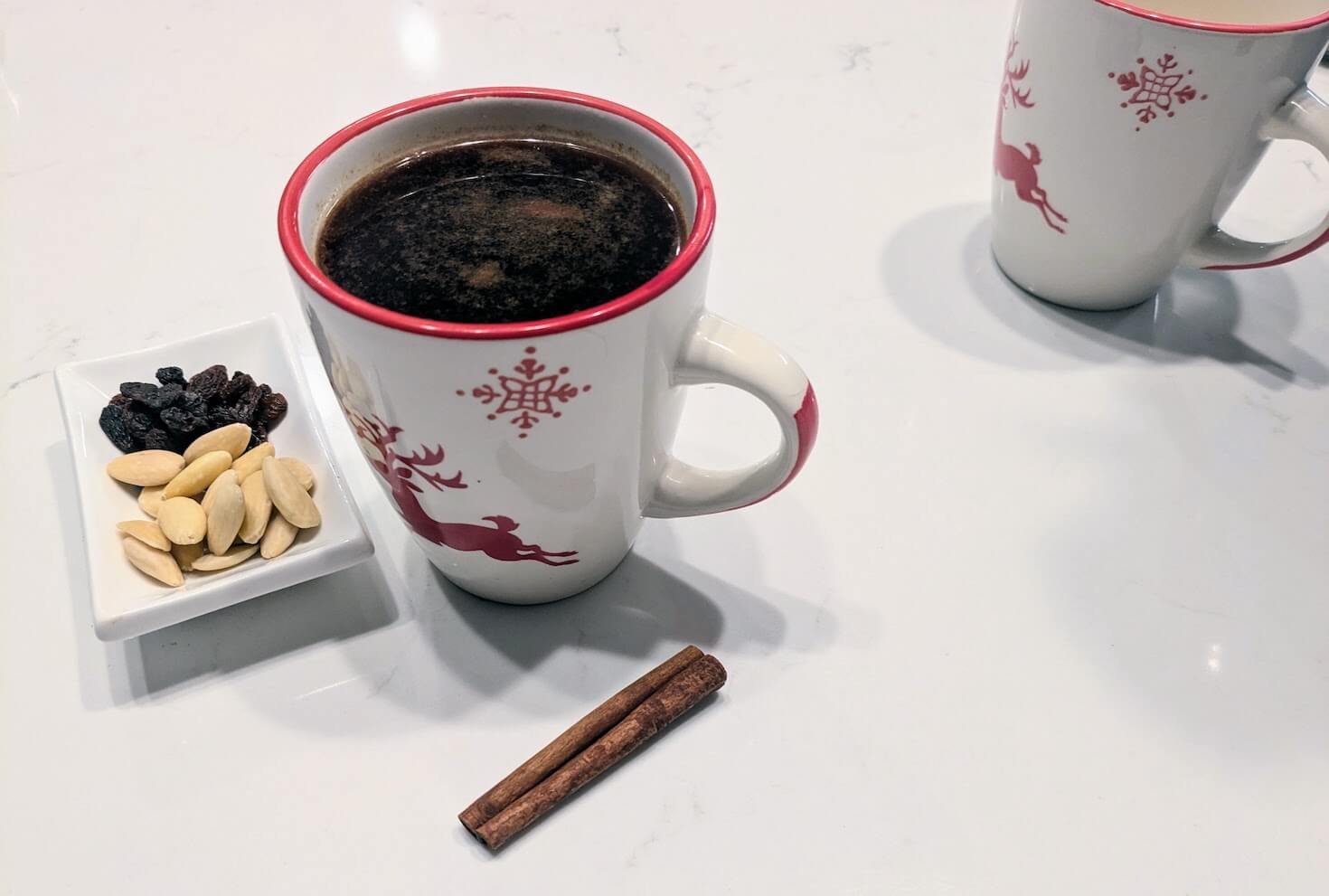 Warm mug of Danish gløgg with spices and almonds