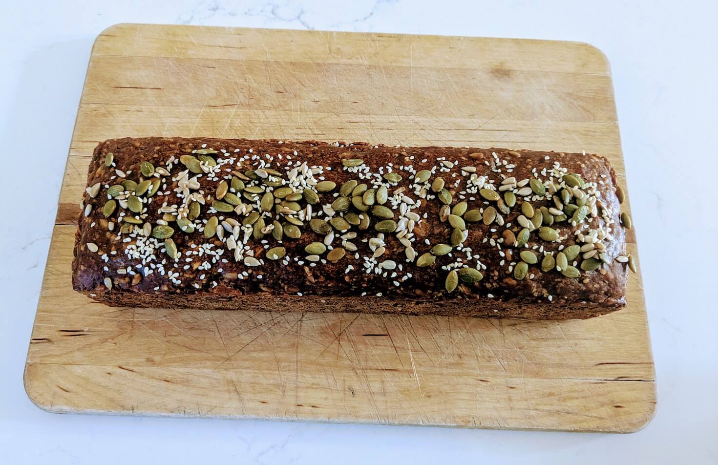 Freshly baked Danish rugbrød (rye bread) on a wooden board