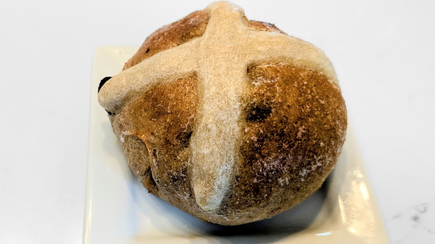 A single sourdough hot cross bun